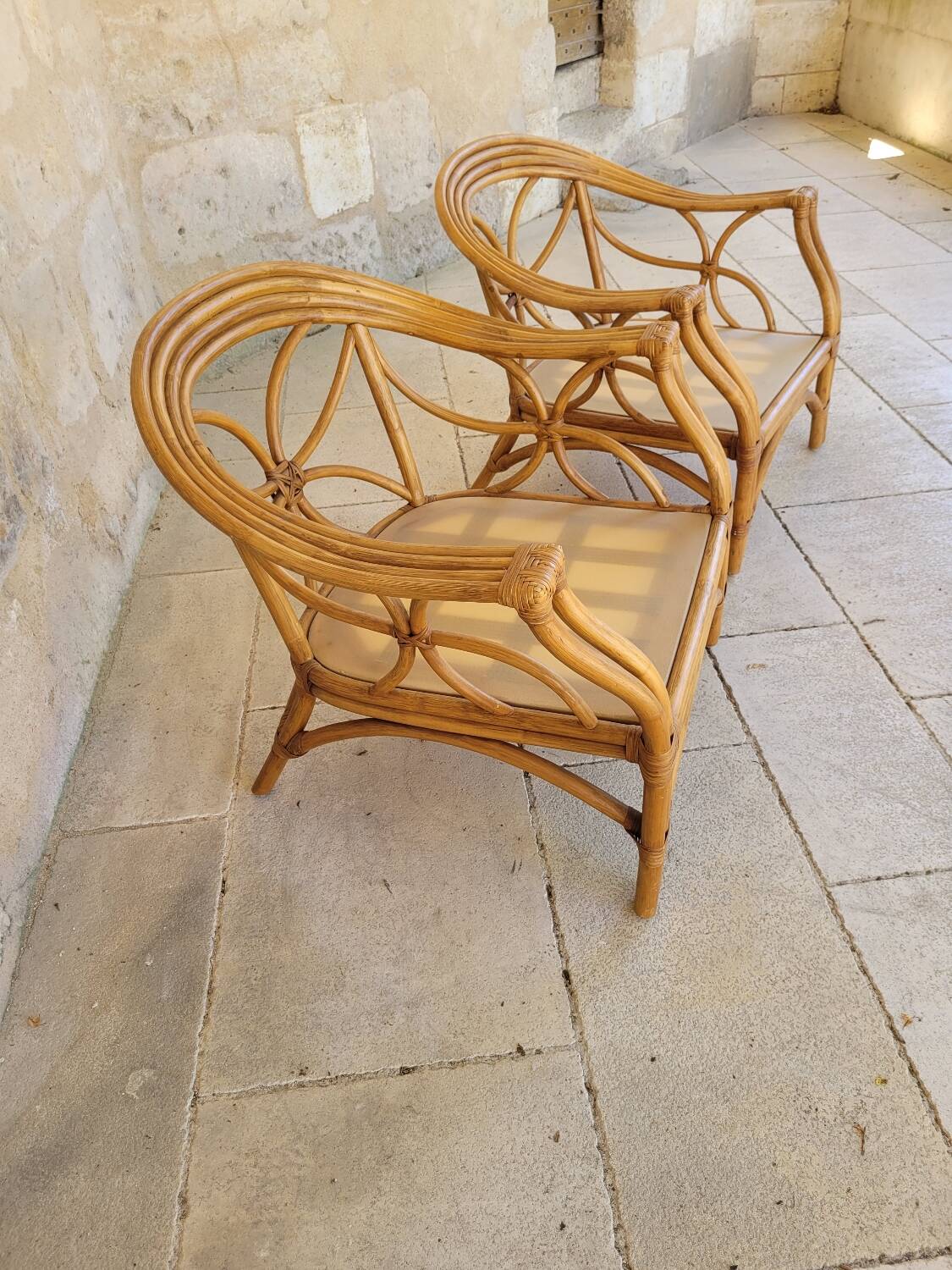 Two large rattan armchairs