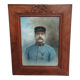 Antique wooden frame with carved portrait knot