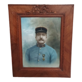 Antique wooden frame with carved portrait knot