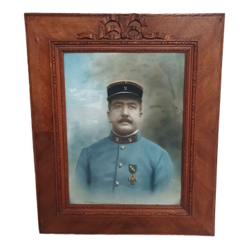 Antique wooden frame with carved portrait knot