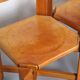 Set of 4 dining chairs in elm wood and cognac leather.