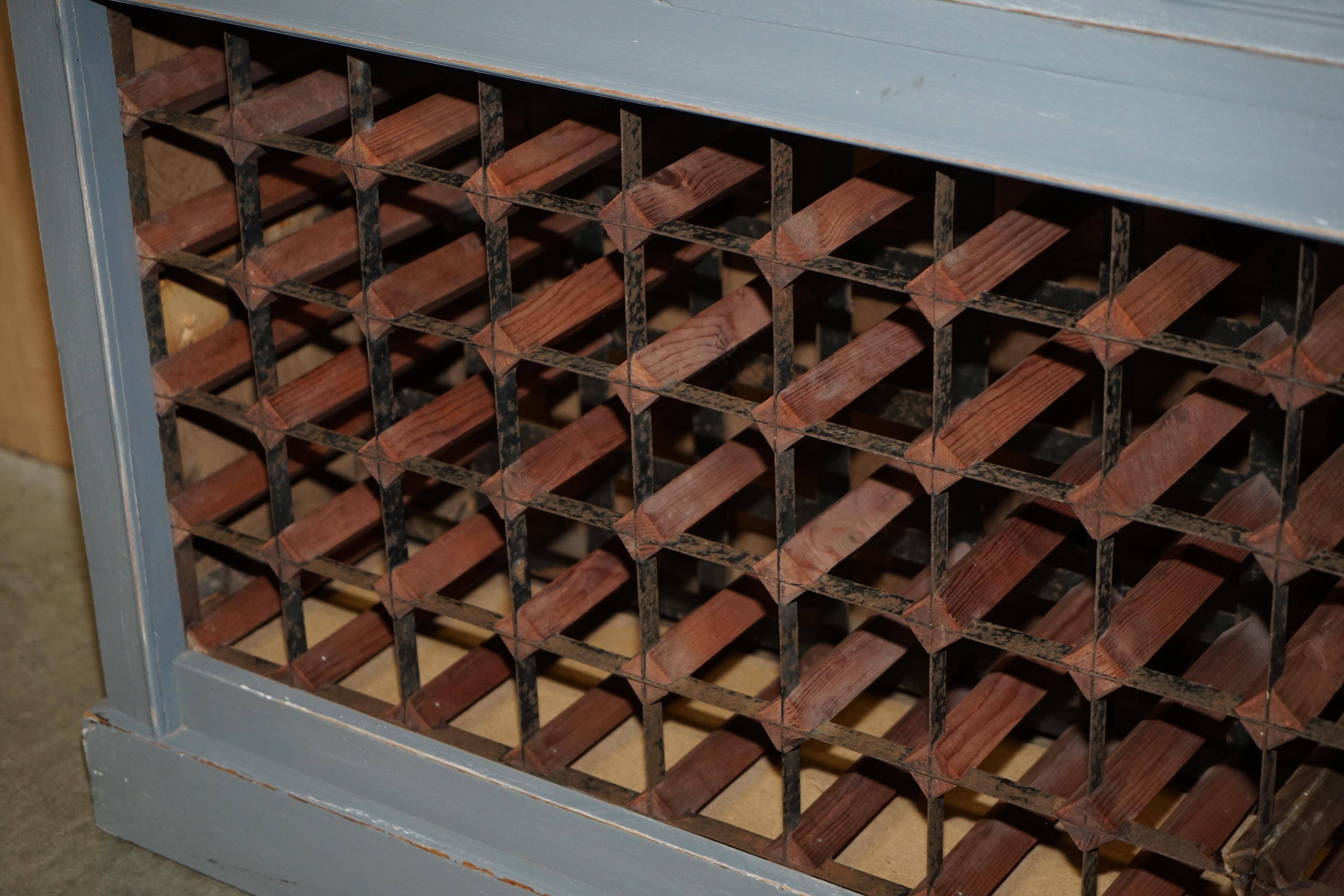 Vintage wooden furniture for 45 wine bottles with a drawer.