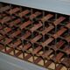 Vintage wooden furniture for 45 wine bottles with a drawer.