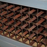 Vintage wooden furniture for 45 wine bottles with a drawer.