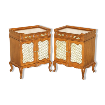 Pair of vintage walnut side cabinets with openwork brass and silk.