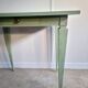 Green side table with tapered legs