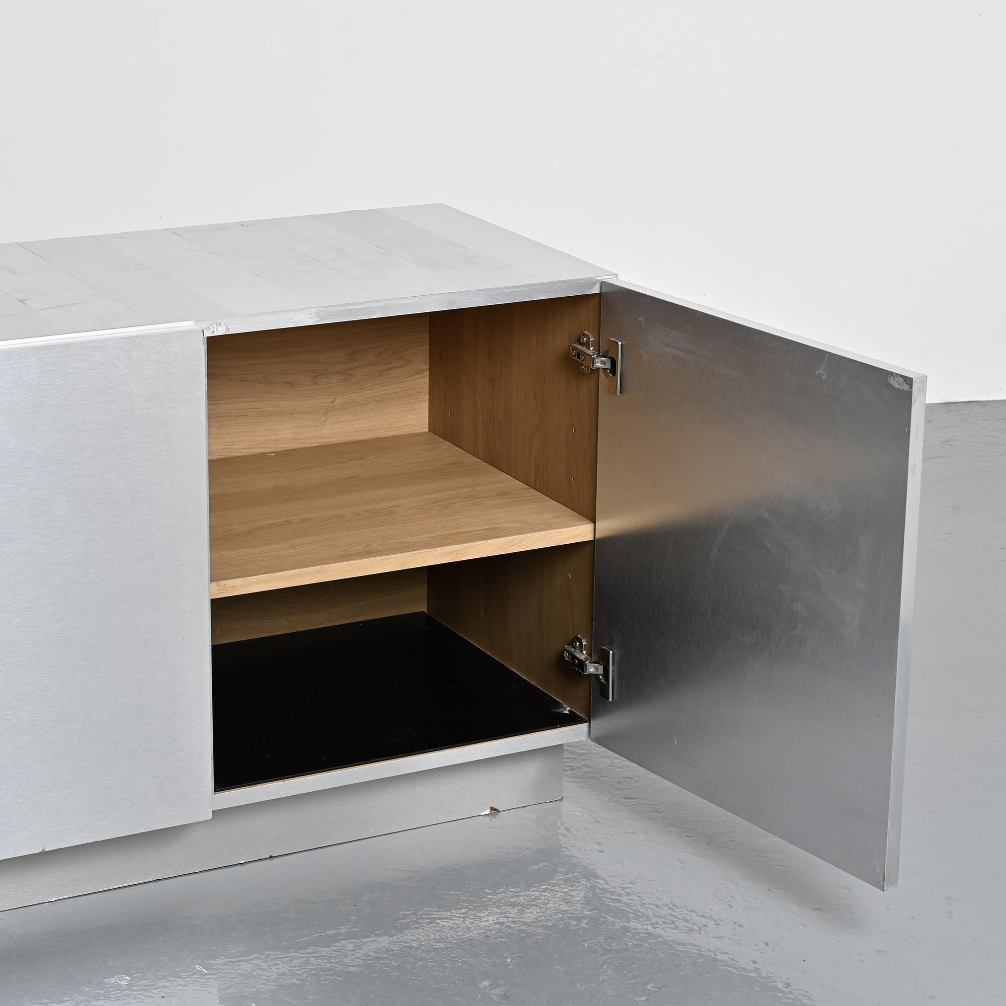 Pair of low buffets in brushed metal, French work, 1970s.