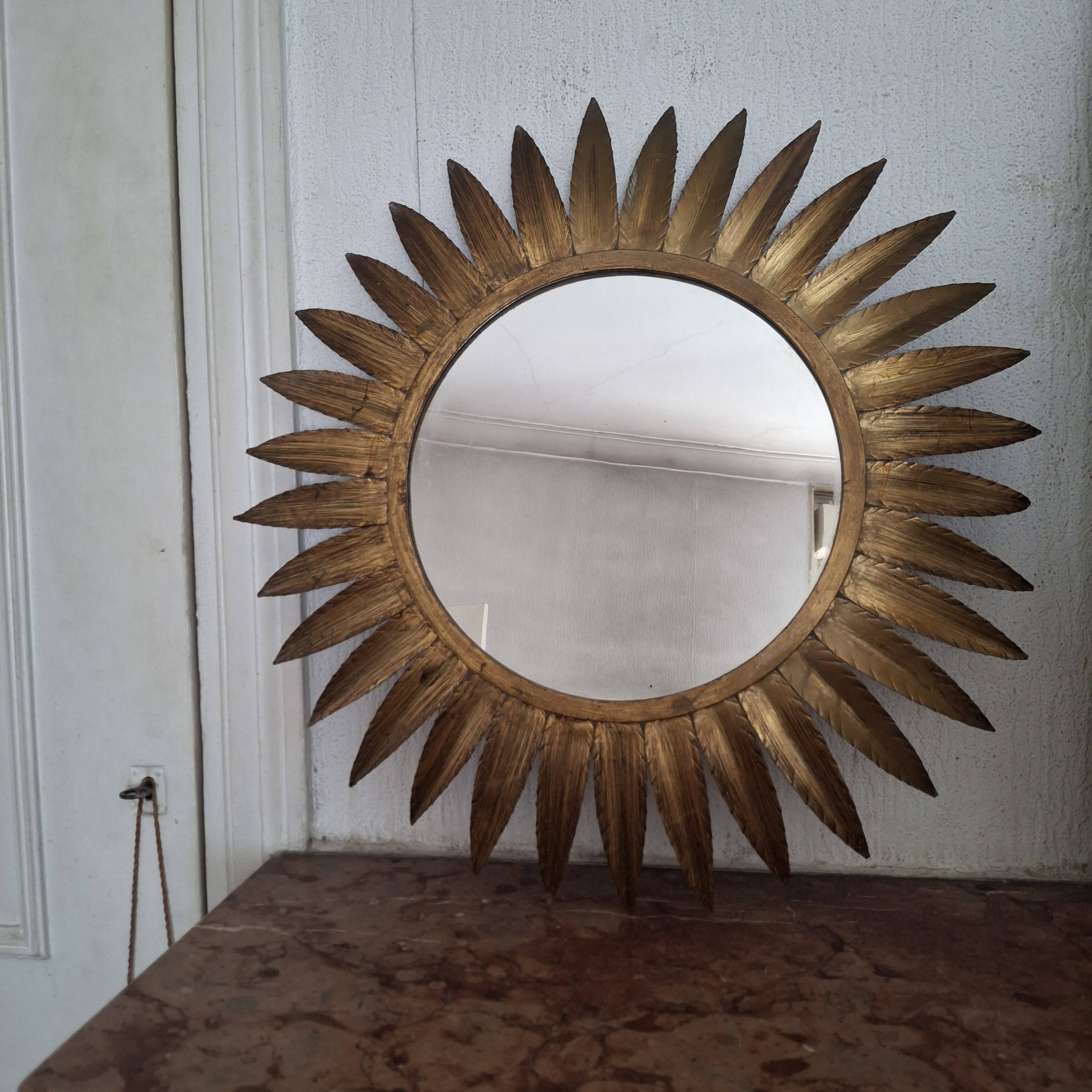 Large sun mirror in gilded metal. 1960
