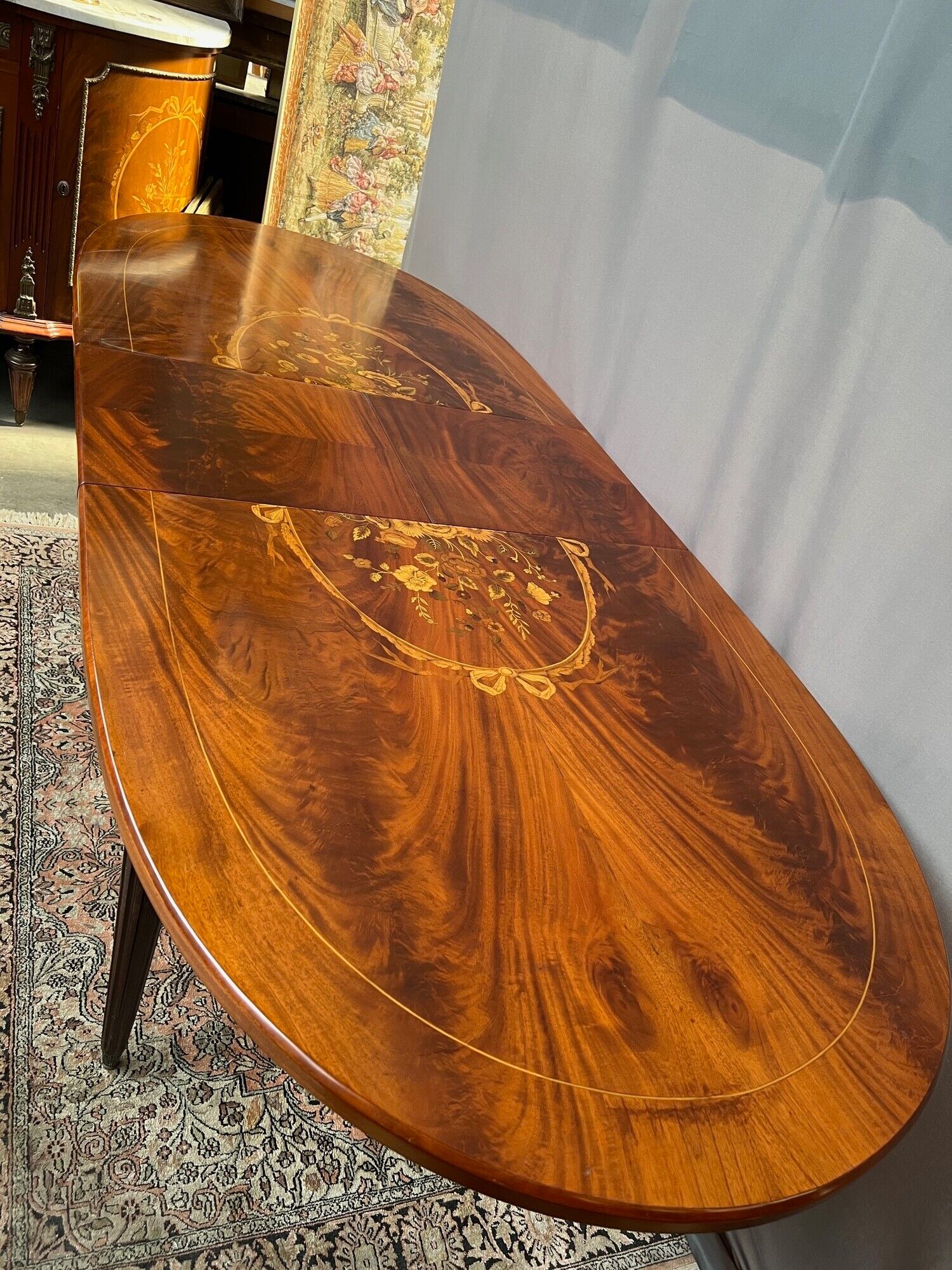 Louis XVI style oval dining table with rosewood marquetry extension mounted in bronze
