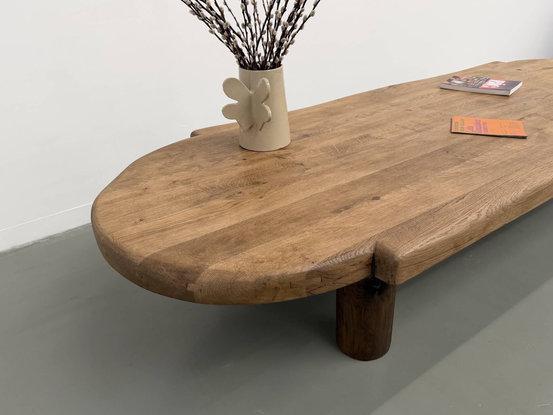 XXL oval coffee table in solid oak, cylindrical base, 1950s.