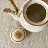 Vintage porcelain and rattan teapot