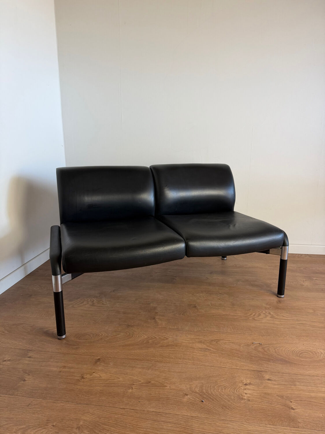 Vintage 2-seater banquette in black faux leather – 1980s