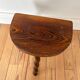 Vintage wooden half-moon tripod stool with twisted legs