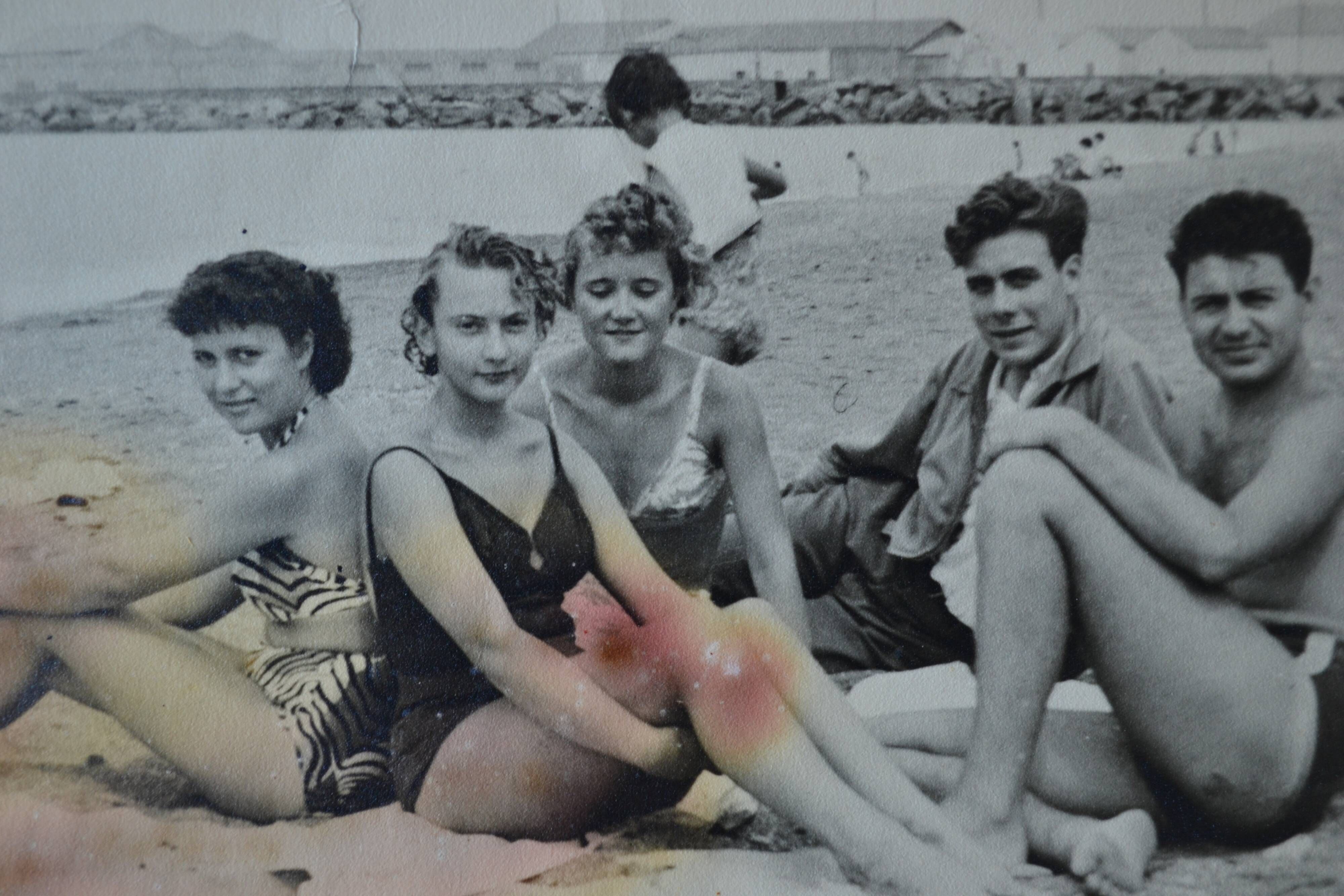 Old film photo circa 1950 the beach group of teenagers