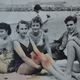 Old film photo circa 1950 the beach group of teenagers