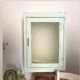 Old medicine cabinet in mint green patinated wood