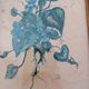 Decorative table with vintage blue flowers in a golden frame.