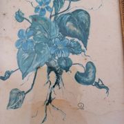 Decorative table with vintage blue flowers in a golden frame.