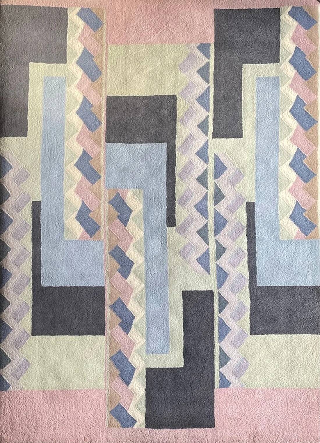 Hand-knotted wool rug by Tisca with a geometric pattern, signed "ILES", France, 1990s.