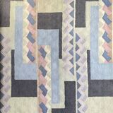 Hand-knotted wool rug by Tisca with a geometric pattern, signed "ILES", France, 1990s.