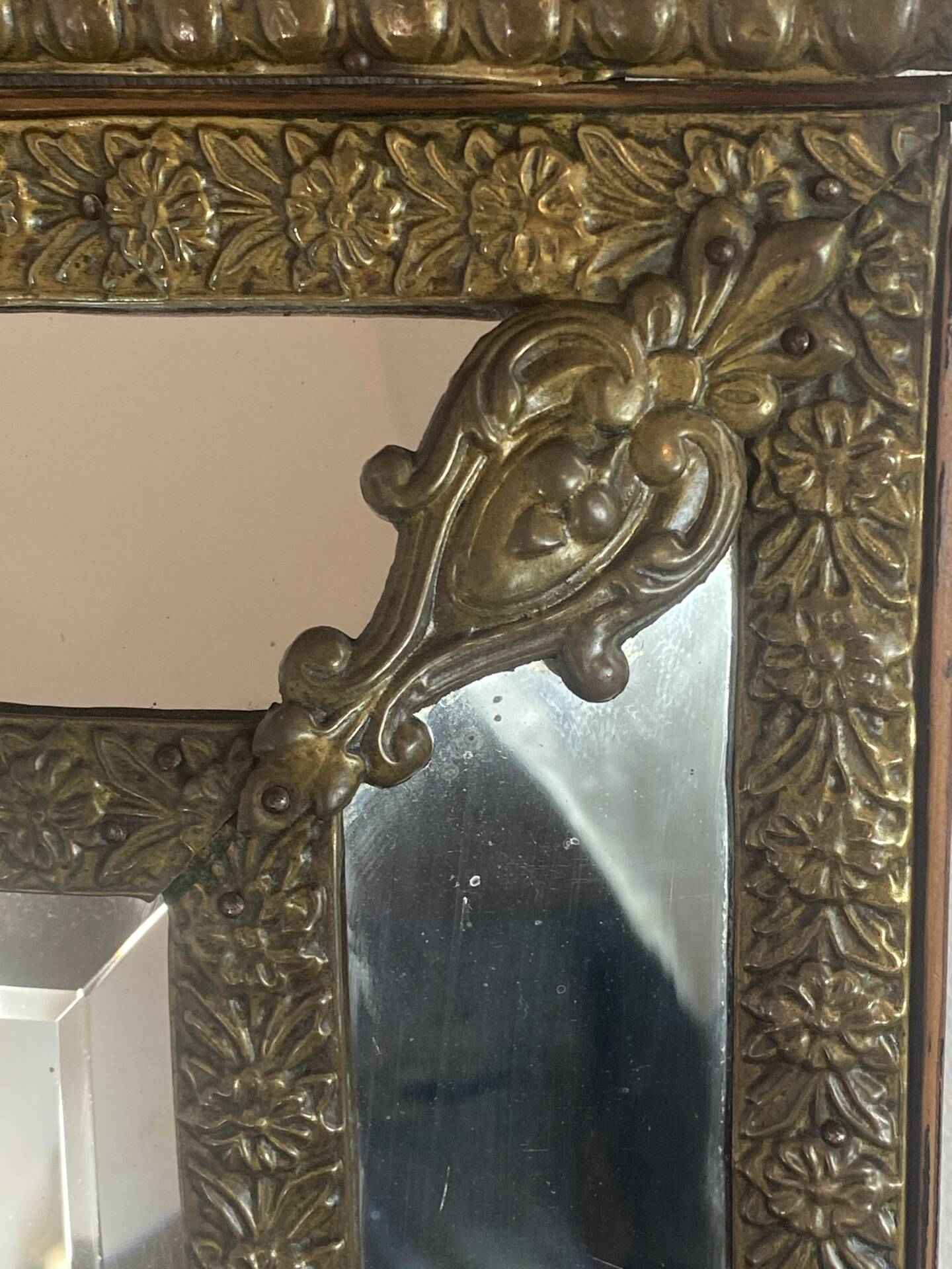 Mirror with brass repoussé frame