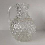 Beautiful and large vintage glass jug with a handle, made of clear hot-worked glass.