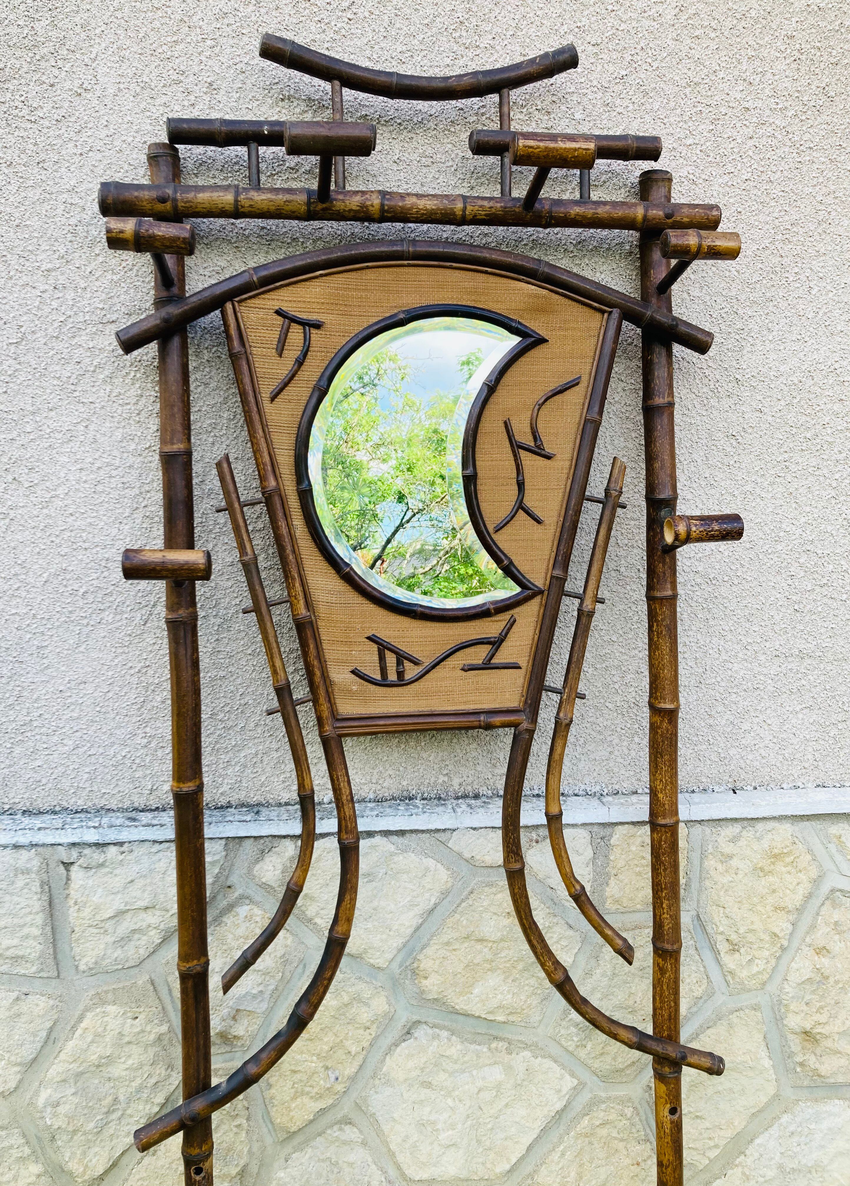 Bamboo coat rack from the 19th century, mirror in the shape of a crescent moon.
