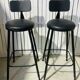 Pair of black bar stools in industrial and contemporary style.