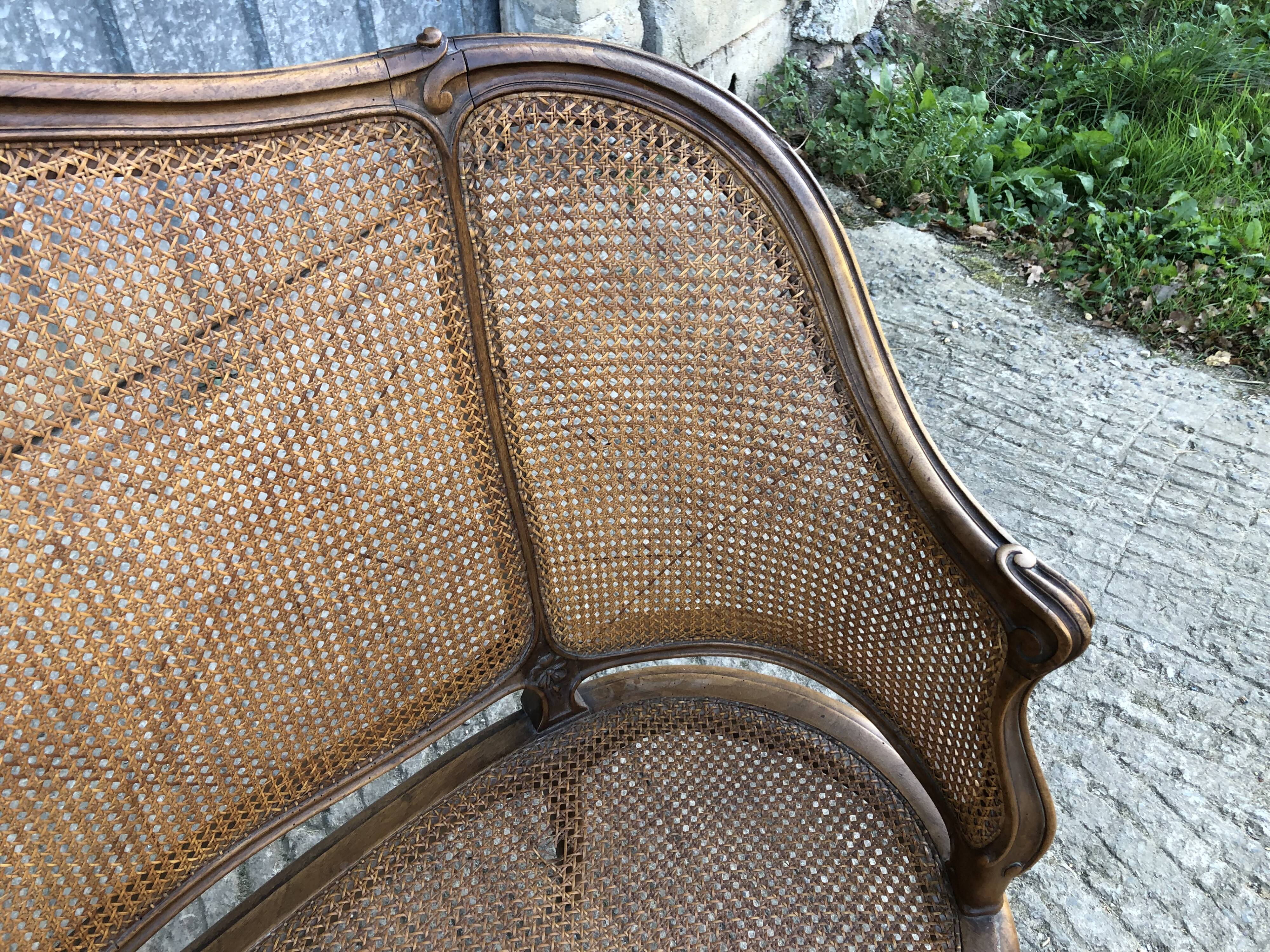 Antique Louis XV bench in solid walnut and caning