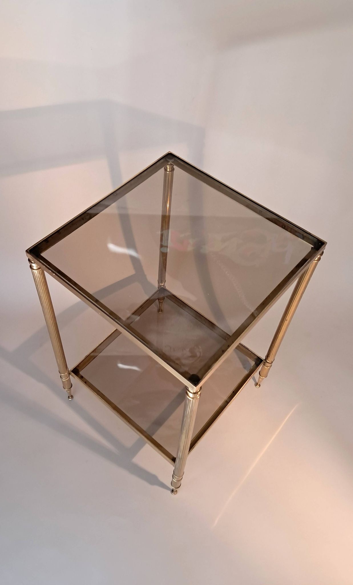 Gilded brass and smoked glass end table, 1960s.