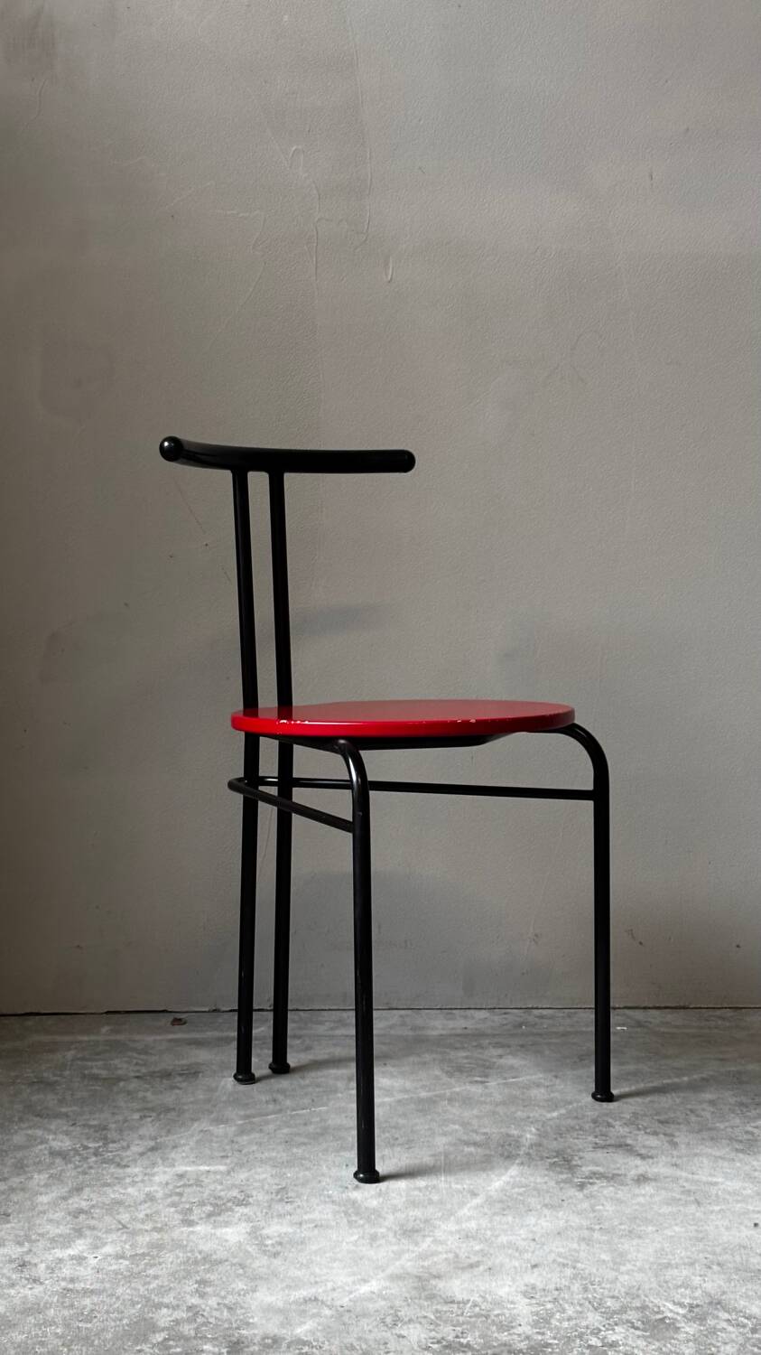 Set of 4 vintage black metal chairs with red lacquered seats.