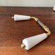 pair of porcelain handle levers with brass rods, antique
