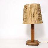 Lamp base in saddle stitched leather and raffia lampshade.