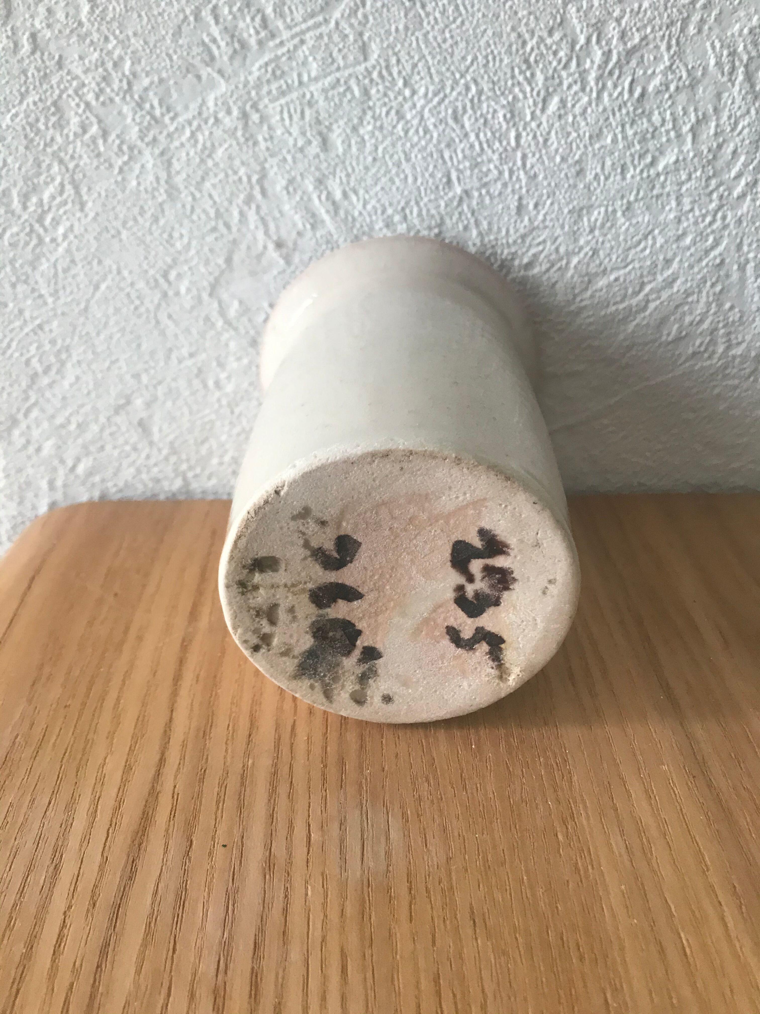 White enamelled sandstone candlestick