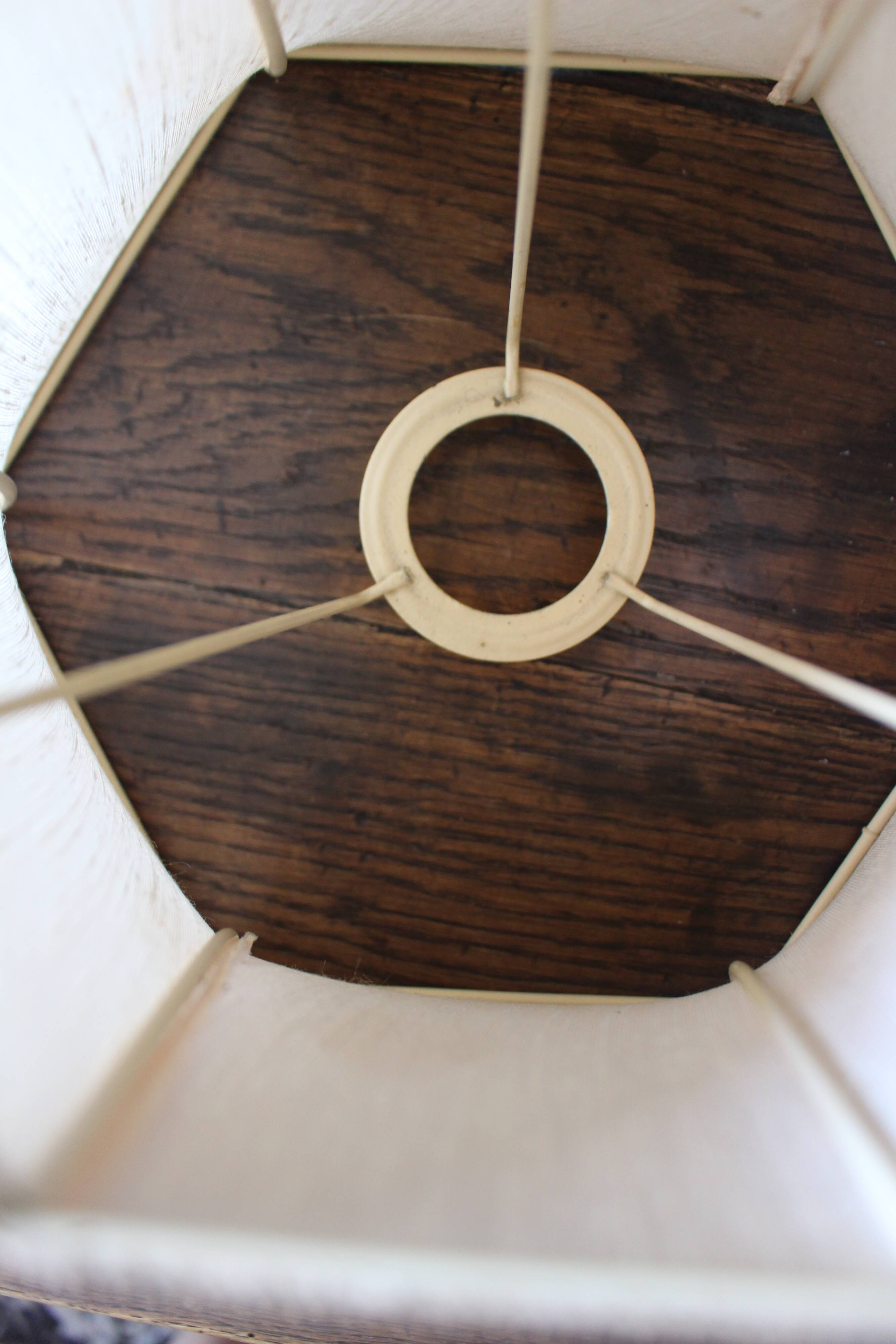 Table lamp with a patinated base and vintage woven shade.