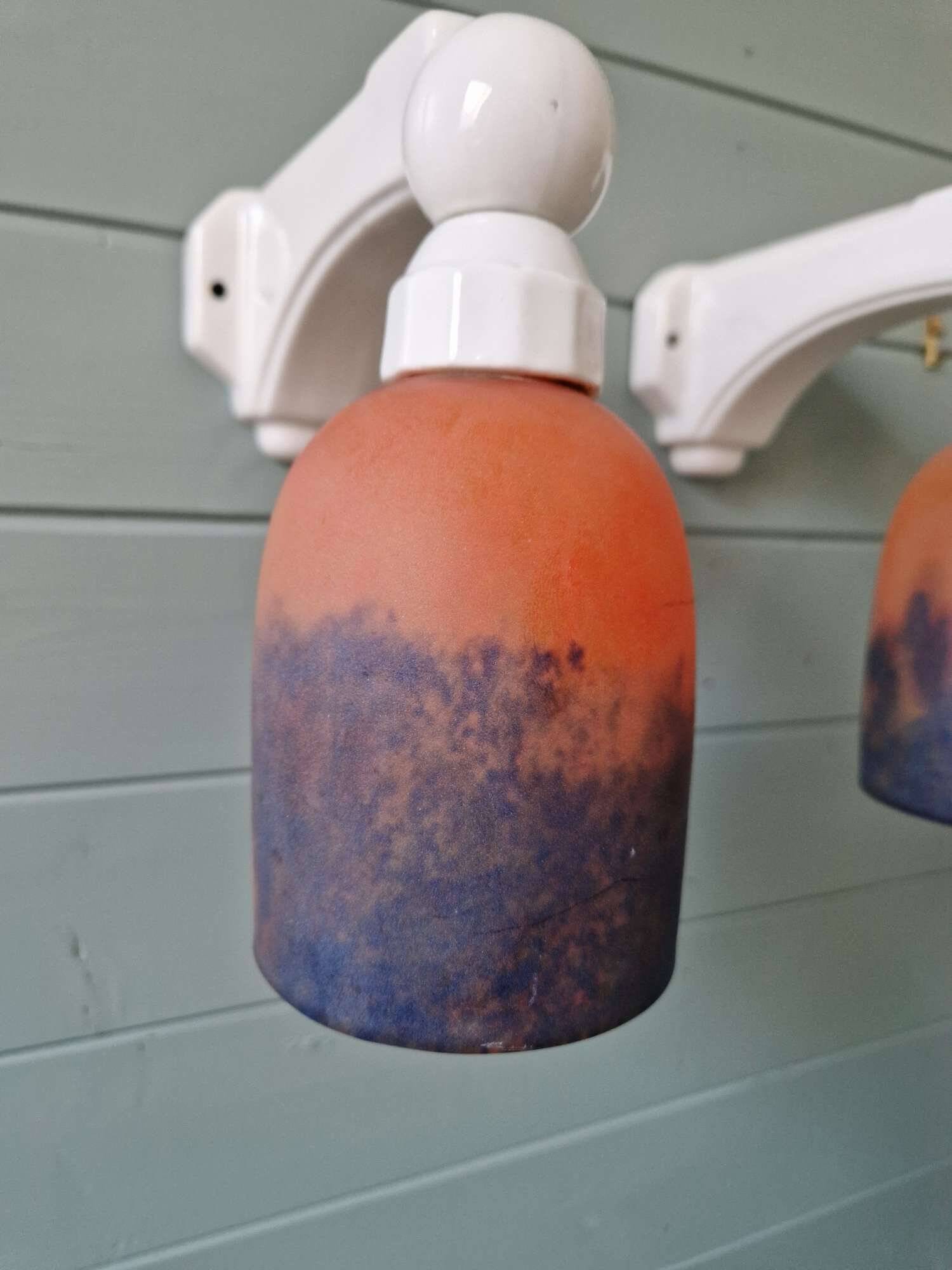 Pair of Art Deco wall sconces in multicoloured porcelain and frosted glass.