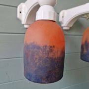Pair of Art Deco wall sconces in multicoloured porcelain and frosted glass.