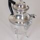 Empire-style silver-plated coffee pot with eagle head spout.