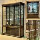 Early 20th-century shop display cabinet in oak with sliding doors.
