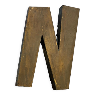 Gold sign letter "N"