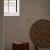 19th-century French round wine table with an adjustable top and floral textile surface.