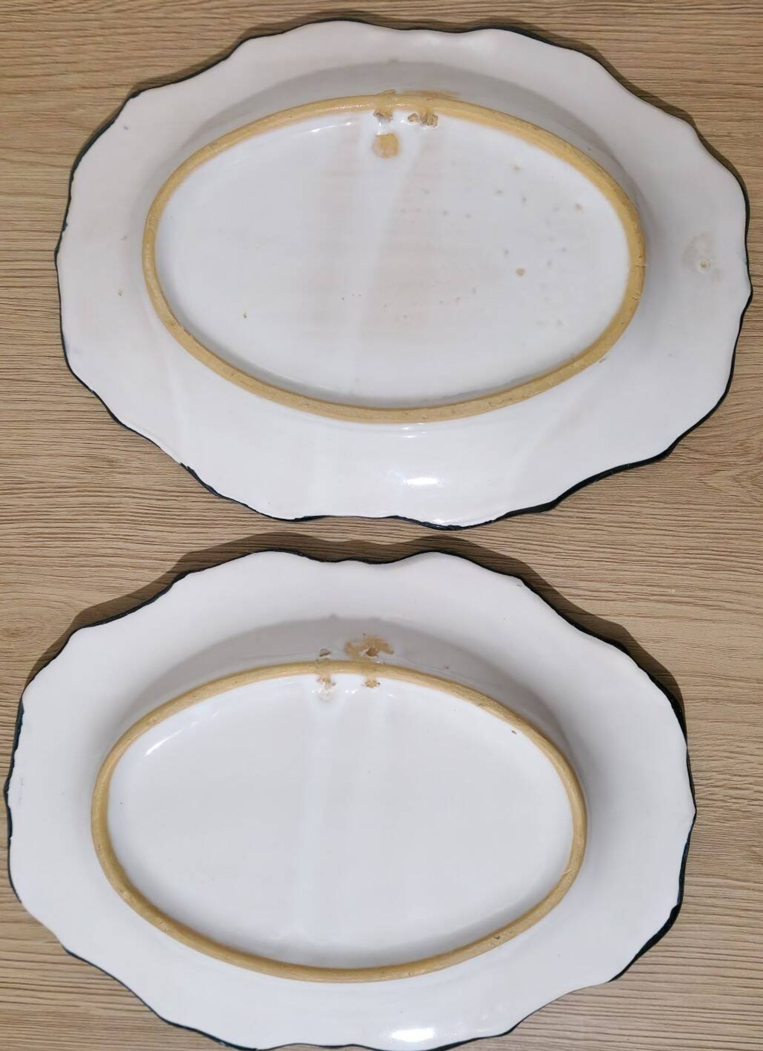 Pair of oval dishes in hand-painted faience with an Italian majolica spirit.