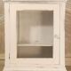 Glazed wall-mounted medicine cabinet in patinated wood
