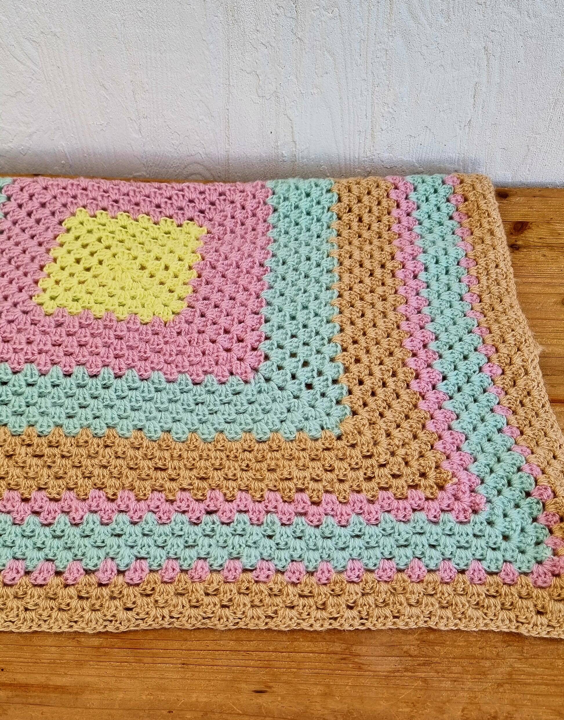Vintage pastel crochet blanket for children.