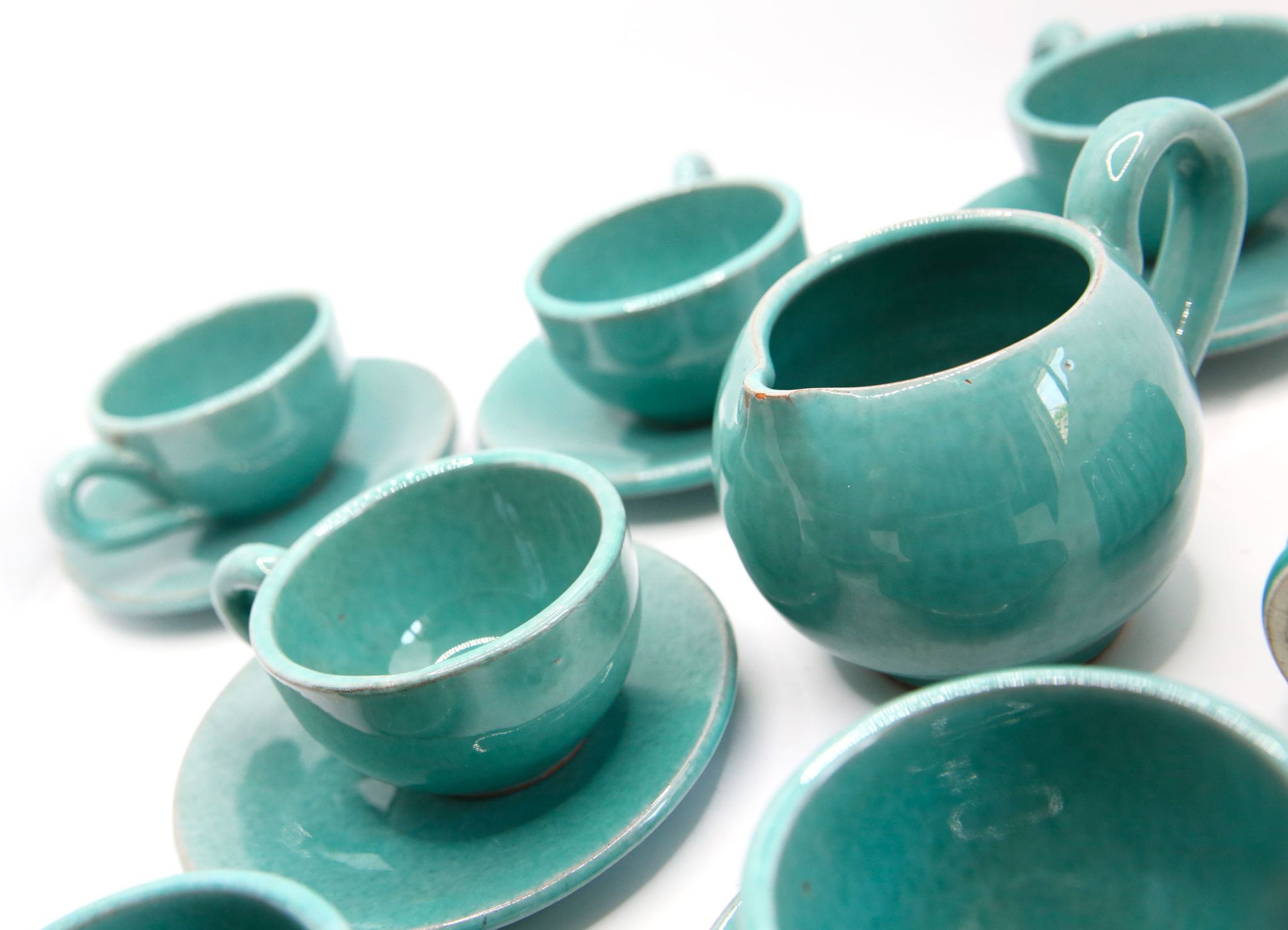 Set of 6 cups in turquoise blue enamelled earth with their saucers and milk jar