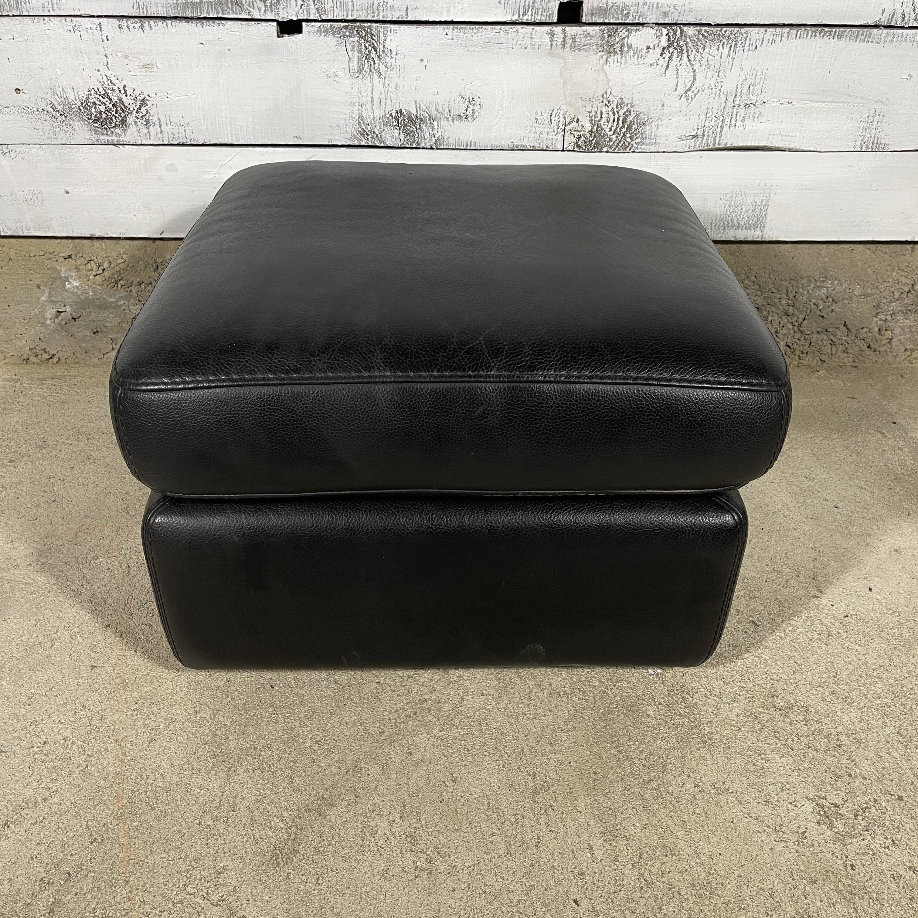 Black leather pouf