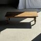 Brown Indonesian teak coffee table, with a border and cylindrical legs H40 L103.
