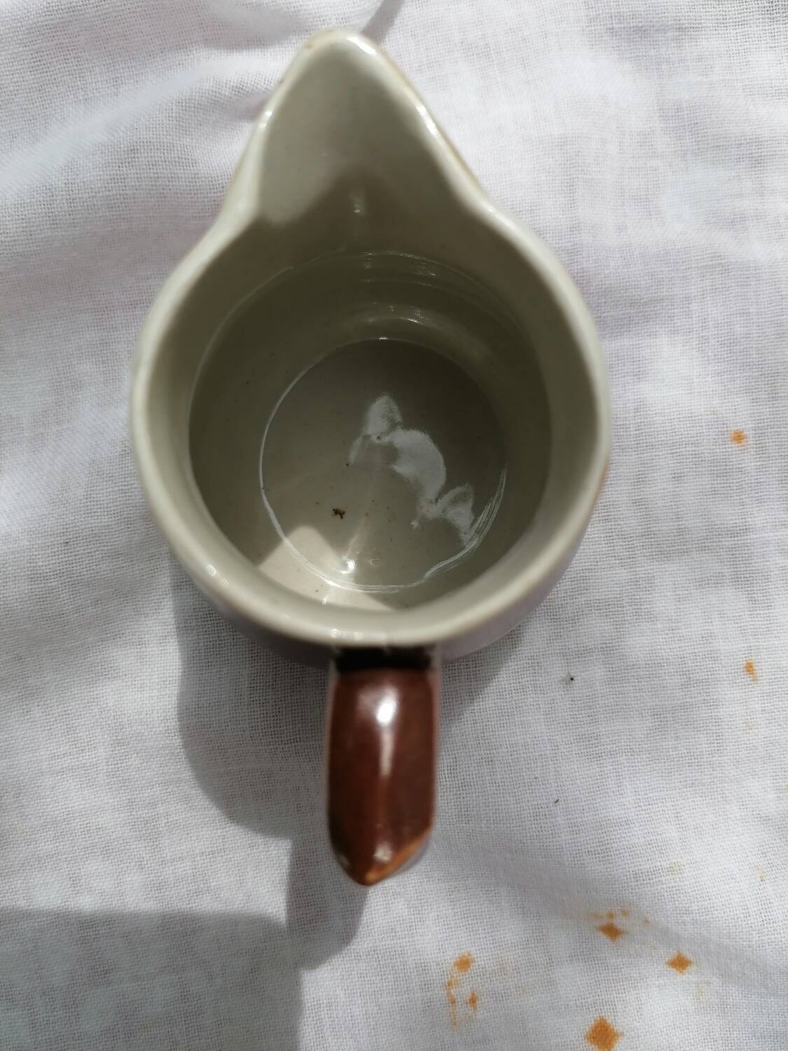 Brown ceramic teapot and milk jugs