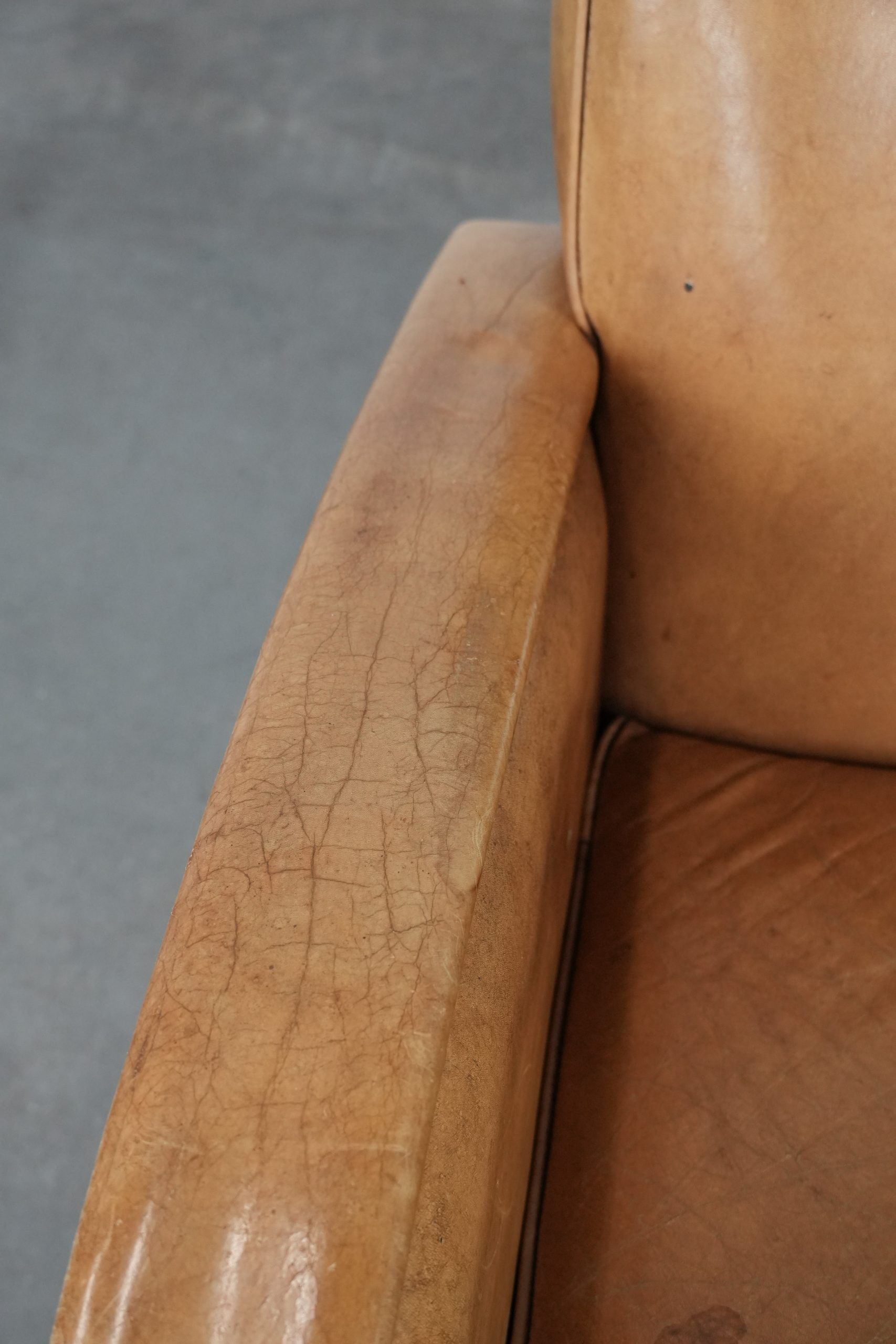 Luxury armchair made of cowhide leather with a beautiful warm colour scheme