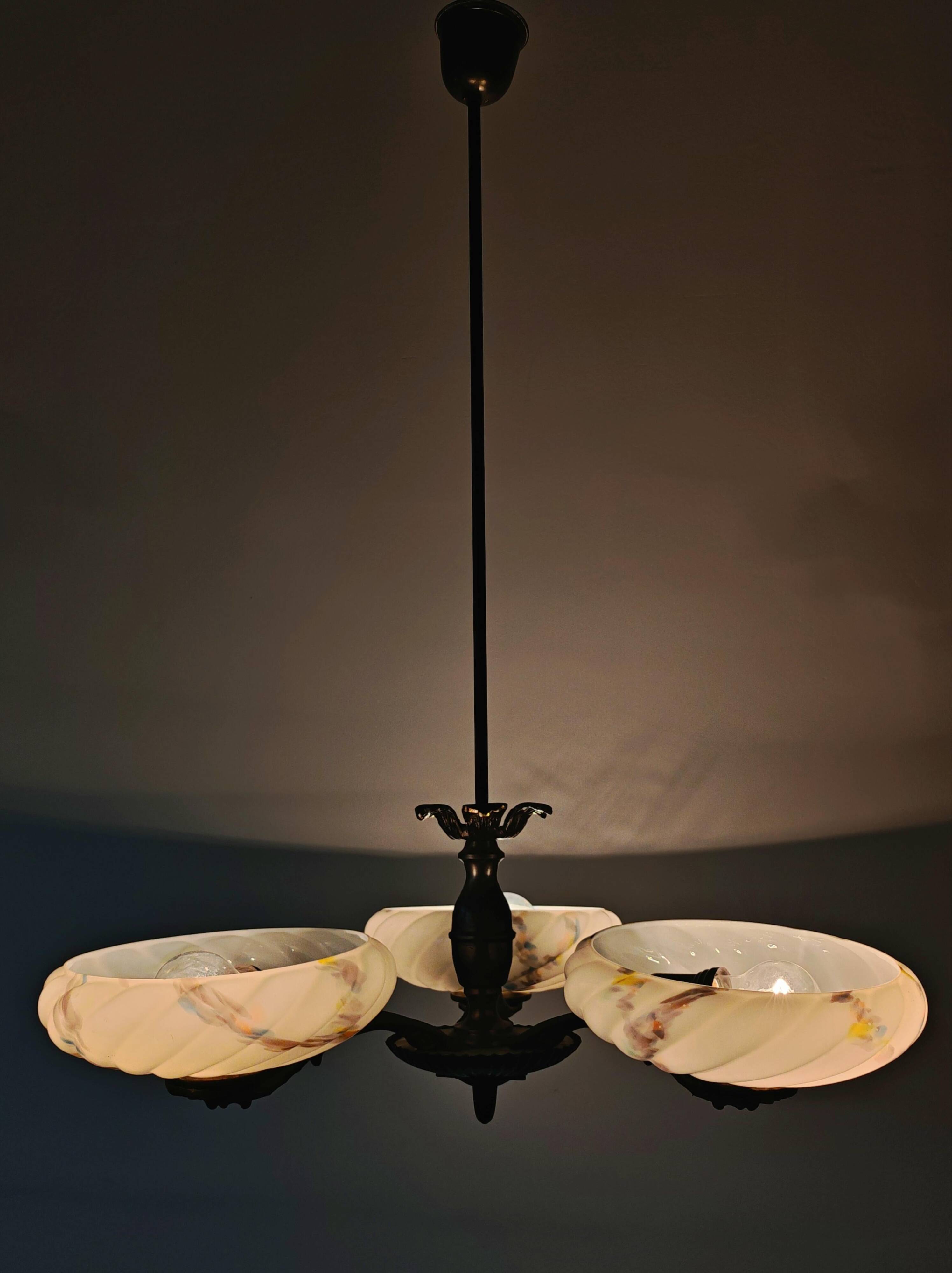 Art Deco bronze three-arm chandelier with marbled glass shades.